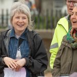 2 women singing and smiling