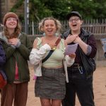 5 young people singing and smiling