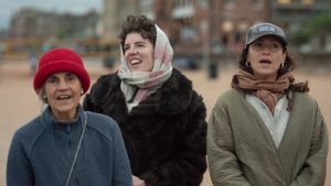 Three women singing happily